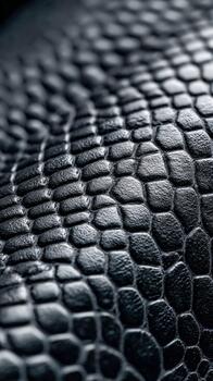 Close-up view of textured black reptile skin with intricate patterns photo