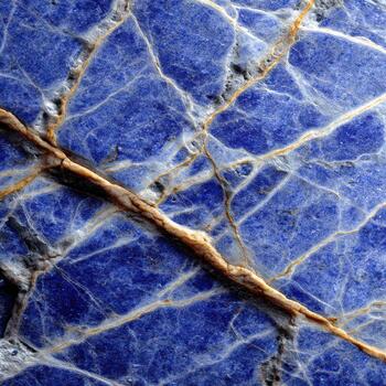 A close up of a blue marble with a gold pattern photo