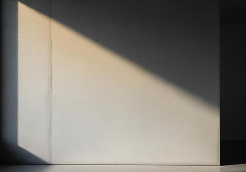 Abstract architectural background featuring diagonal sunlight casting sharp shadows on a concrete wall photo