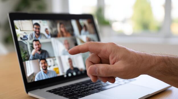 A close-up of a hand pointing at a laptop screen showing a virtual meeting of diverse participants. photo