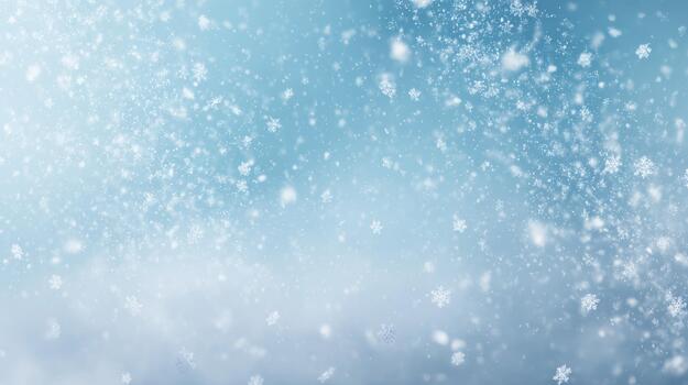 Snowflakes gently falling against a soft blue backdrop, creating a serene winter atmosphere. photo