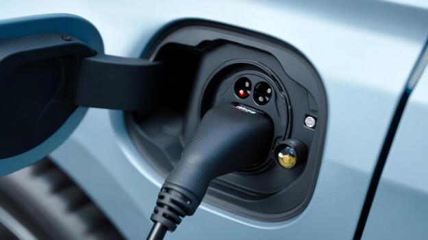 Close-up of an electric vehicle charging port, showcasing its sleek design and modern technology. photo