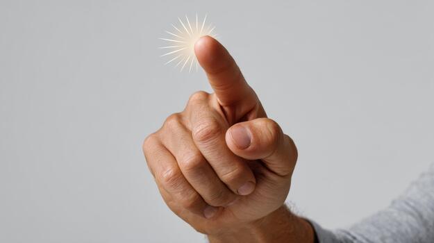 A close-up of a male hand pointing with a glowing effect, symbolizing innovation and creativity. photo