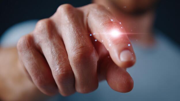 A close-up shot of a male hand pointing with a glowing effect, conveying a sense of action and magic. photo