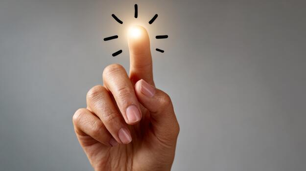 A close-up of a human hand with a glowing fingertip, symbolizing creativity and inspiration. photo