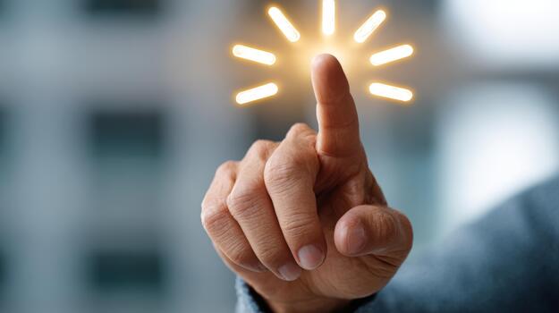 A close-up of a male hand reaching out with a finger, surrounded by glowing rays, symbolizing innovation and creativity. photo