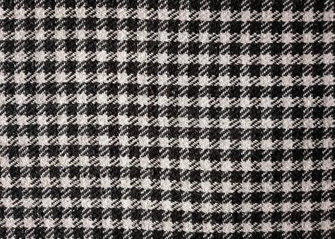 Classic Black and White Houndstooth Fabric Woven Textile with Repeating Abstract Four-Pointed Pattern photo