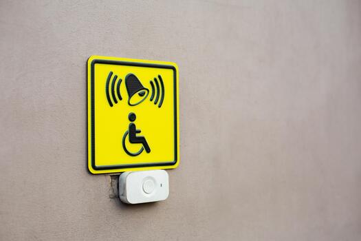Concept photo on accessibility for people with disabilities with space for text. Project about people with injuries and physical disabilities. Wall with help button and symbol of person in wheelchair