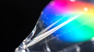 Abstract Prism Rainbow Light on Glass with Dark Background, creating a vibrant spectacle with refraction, bokeh effects, and glittering light dispersion 4k video