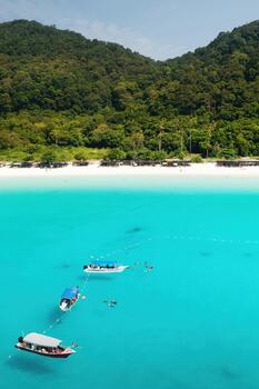 View of the tropical beach on Redang Island. Turtle beach with tourists and boats on Redang Island in Malaysia, photo