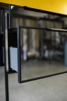 Modern black metal table design with open drawer showcasing sleek lines and minimalist style in a contemporary workspace setting photo