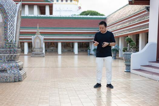 Counting for Donation, he stands quietly in the temple courtyard, counting small coins, preparing to give what he can, a gentle reminder of kindness in simplicity. photo