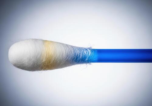 Close up of a used cotton swab isolated on white background photo