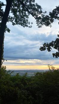 Sunset over rolling valley in Southern Illinois framed by trees at dusk with quiet colors photo