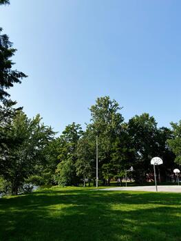 Sunny park scene with green grass trees and basketball courts in Southern Illinois on a clear day photo