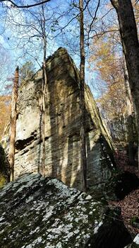 Ancient rock formation surrounded by trees in a southern Illinois forest scene photo
