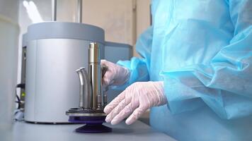 Dentistry tools are being placed on the part of the sterilizing machine. Medical worker puts the instruments into a sterilizer. video