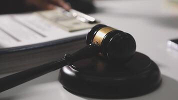 A judge's gavel on a desk with a stack of papers and a pen video