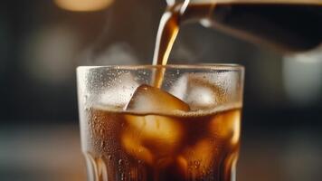 Rich, dark coffee is poured over ice cubes in a clear glass, creating a refreshing and invigorating beverage perfect for any time of day video