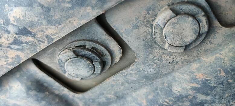 Close-up of rusty industrial bolts and mechanical parts covered in dirt and dust. Abstract background of metal fasteners and machinery components, showing details of engineering and construction photo