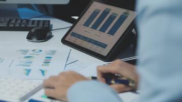 A person is working on a tablet computer with a chart on it video