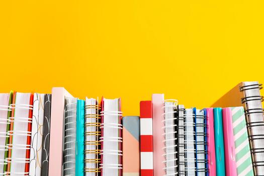 Stack of colorful books against background, space for text photo