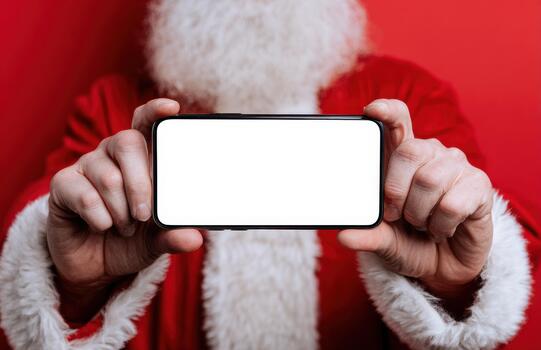 Santa showing horizontal smartphone with blank screen at Christmas photo