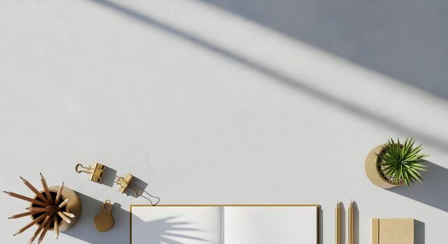 Modern minimalist workspace flat lay featuring stationery notebook plant and soft shadows providing neutral background photo