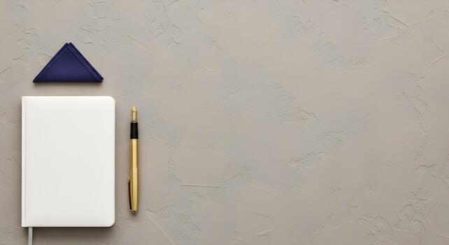 Elegant workspace with blank notebook gold fountain pen and blue handkerchief on grey textured background photo