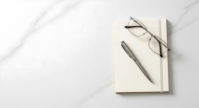 Minimalist Workspace Flat Lay Featuring Notebook Pen and Glasses on White Marble Surface for Creative Work photo