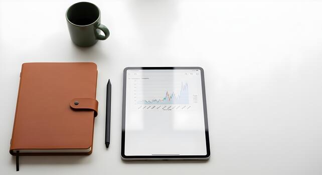 Modern workspace with tablet displaying financial charts surrounded by notebook and coffee mug showcasing productivity photo