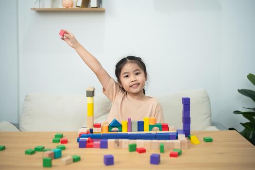 Happy child playing with colorful building blocks at home, creating structures and learning through play in a bright and inviting environment photo