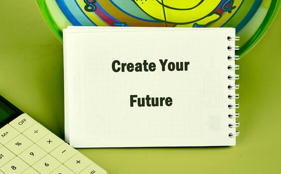 A spiral sketchbook displays the phrase Create Your Future near a calculator and clock, all against a plain Green backdrop, suggesting planning and time management photo