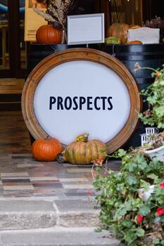 Lead Generation and converting them into Customers concept. Copy space. PROSPECTS written on Vibrant autumn display with colorful pumpkins and rustic decor photo