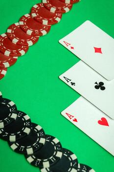 Winning cards with a combination of three of a kind or set are neatly laid out on a green table in the club, and chips. The atmosphere is charged with the excitement of a good win in a poker game photo