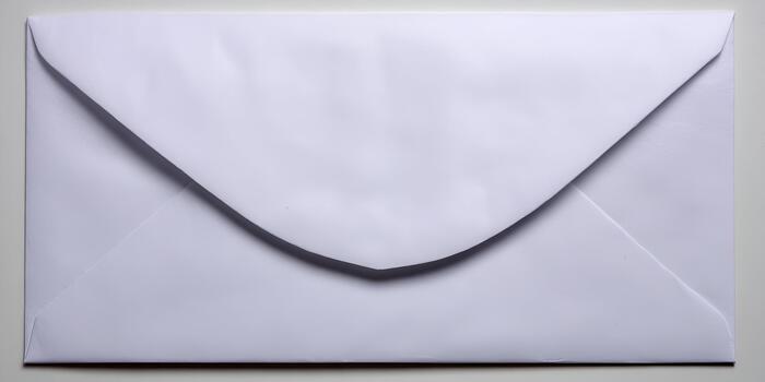 A simple white closed envelope rests on a plain background ready for mail and communication photo