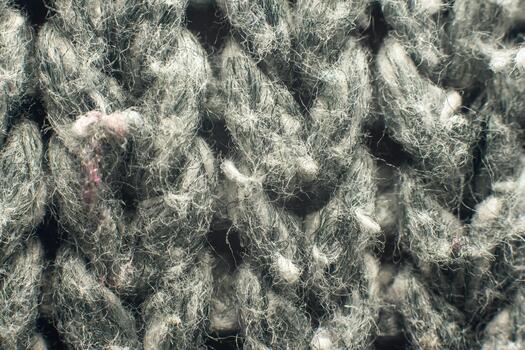 Macro texture of grey wool knit, close-up of the fibers and threads of the fabric. photo