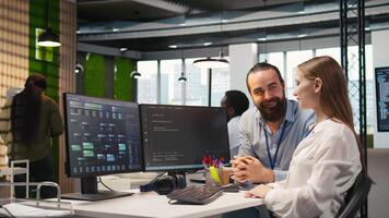 vänlig team ledare portion Lycklig ung ingenjör koda ai algoritmer till debug programvara frågor och förbättra systemet stabilitet. hjälpsam chef bistå leende internera i tech börja kontor, kamera en video