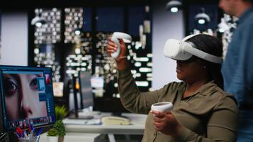 African american woman uses VR headset and AI to edit photos, retouching content and generating professional materials. Graphic editor turning text to image with virtual reality. Camera B. video