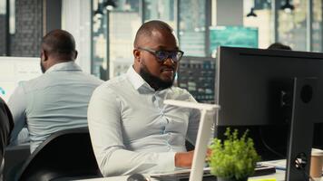 o negócio colegas revendo arquivos e gráficos durante uma estratégia resumo. empregados dentro uma multinacional companhia compartilhar intuições e coordenada tarefas usando pc e visual dados ferramentas. Câmera b. video