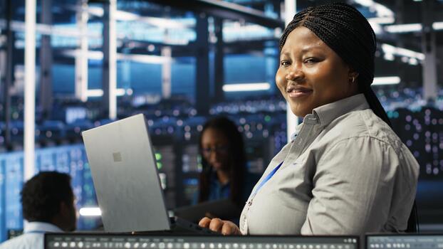 Portrait of joyous server hub technician using AI visualization insights to optimize system health. Joyful data center IT expert analyzing gear issues using node tree tools, camera B photo