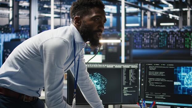 Server farm supervisor and man with disability adjust system settings based on AI analytics. Data center manager talking with technician in wheelchair overseeing automated node tree tool, camera A photo