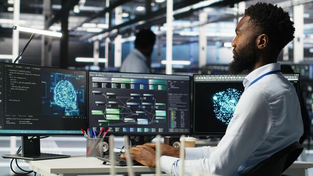 Data center programmer uses machine learning node tree program to identify equipment issues. Server hub worker reviewing artificial intelligence data analysis graph to minimize failures, camera B photo