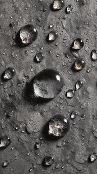 Water Droplets Gather on a Dark Surface Creating an Artistic and Textured View in Natural Light photo