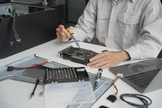 Closeup hand of computer hardware technician dissemble and fixing computer PC photo