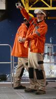 Vertical Offshore expert in VR headset simulating extraction and maintenance tasks, using futuristic technology to improve safety, efficiency and performance in the oil and gas industry. Camera A. video