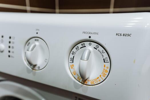 washing machine control panel, modern home with eco washing cycle, closeup of laundry machine dial with program options, washing machine interface displaying eco mode in contemporary environment photo