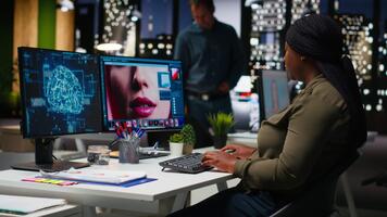 African american woman photographer uses neural networks system to edit photos, creating professional content with artificial intelligence. AI powered software for retouching on pc. Camera B. video