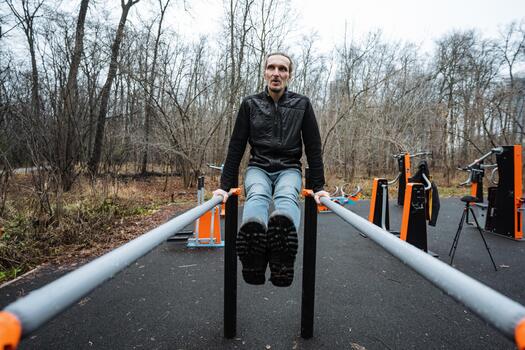 white trainer demonstrating dip on parallel bars with calm focus, controlled movement and visible muscle engagement, public outdoor gym setting, overcast mood and disciplined technique photo
