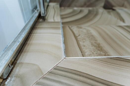 foam cleaner showing differences, visual comparison of stained tile corner before and after cleaning, marketing display demonstrating effective stain removal on tile using foam cleaner photo